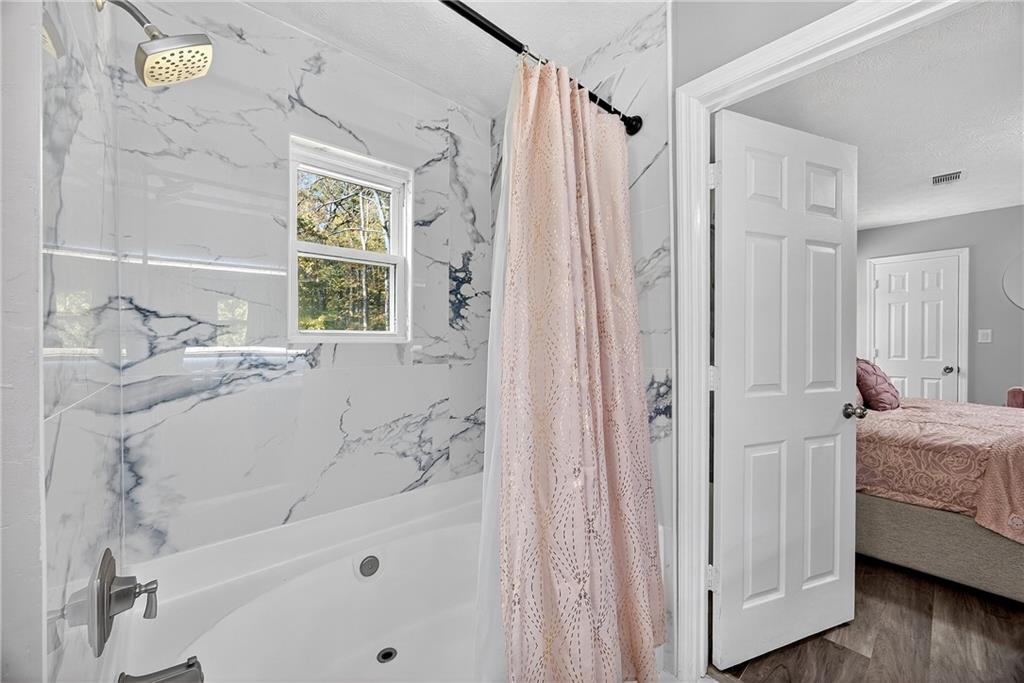 146 Highview Road Southeast Milledgeville, GA 31061 - Photo 14 of 30 a bathroom with a tub shower and a sink