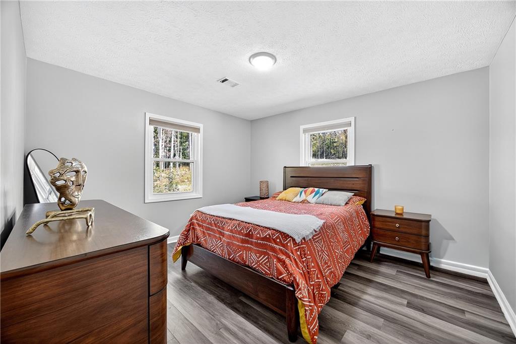 146 Highview Road Southeast Milledgeville, GA 31061 - Photo 16 of 30 a bedroom with a bed and wooden floor