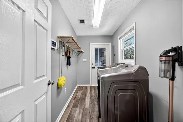 a view of a bedroom with washer and dryer