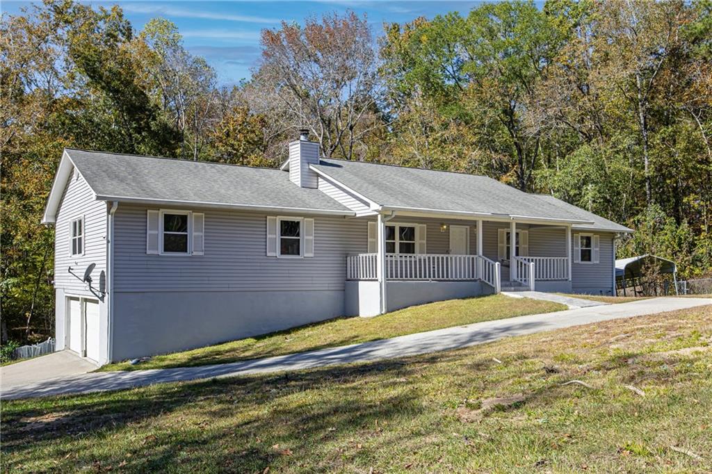 146 Highview Road Southeast Milledgeville, GA 31061 - Photo 3 of 30 a front view of a house with a yard and trees