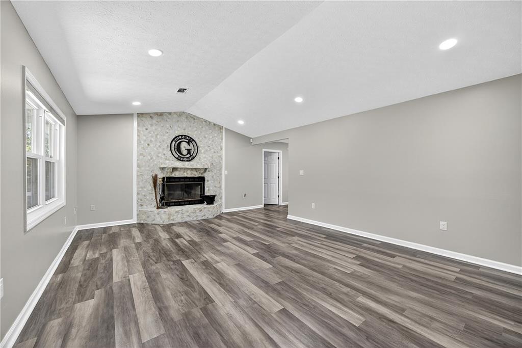 146 Highview Road Southeast Milledgeville, GA 31061 - Photo 4 of 30 a view of empty room with wooden floor and fireplace