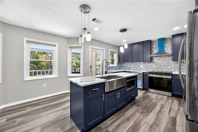 a kitchen with stainless steel appliances granite countertop a stove and cabinets