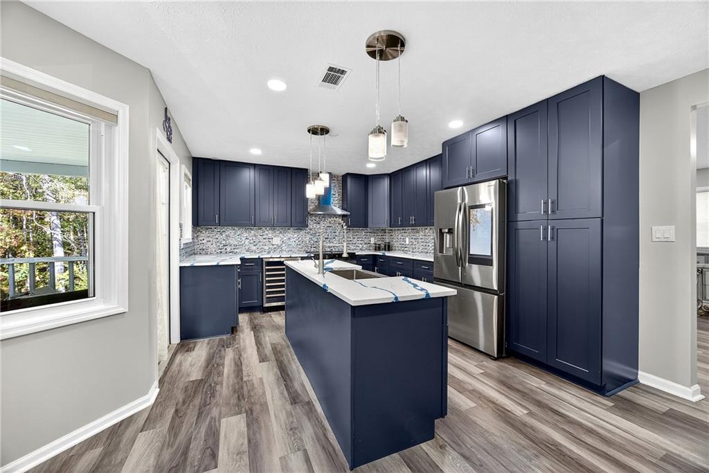 146 Highview Road Southeast Milledgeville, GA 31061 - Photo 8 of 30 a kitchen with kitchen island granite countertop wooden cabinets a sink and a stove