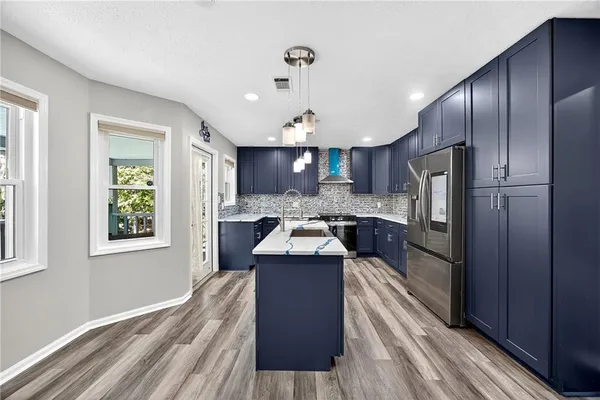 a kitchen with a refrigerator a sink and dishwasher