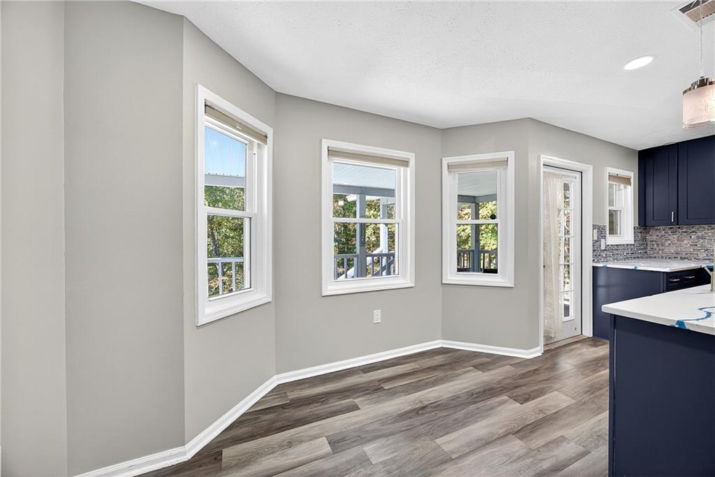 146 Highview Road Southeast Milledgeville, GA 31061 - Photo 10 of 30 an empty room with wooden floor and windows