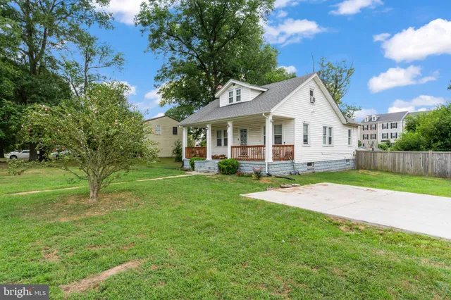 a view of backyard of house with green space