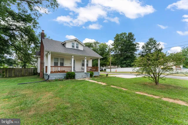 a view of a house with a yard porch and sitting area