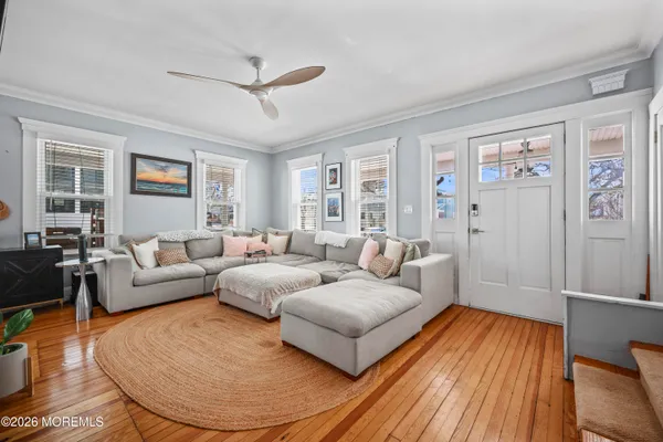 a living room with furniture and a wooden floor