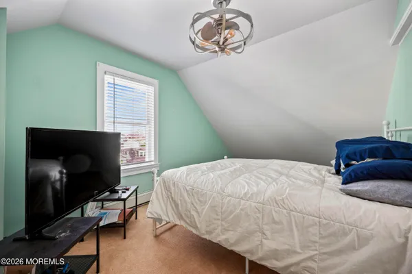 a bedroom with a bed and a television