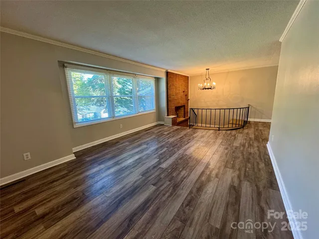 a view of a room with wooden floor and outdoor space