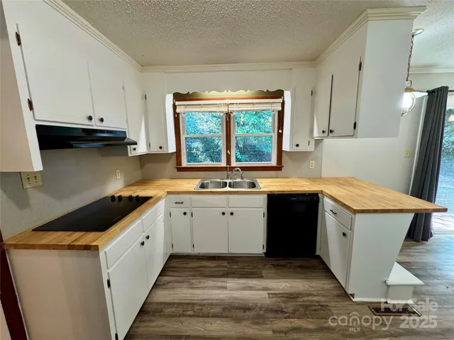 a kitchen with a sink stove top oven and cabinets