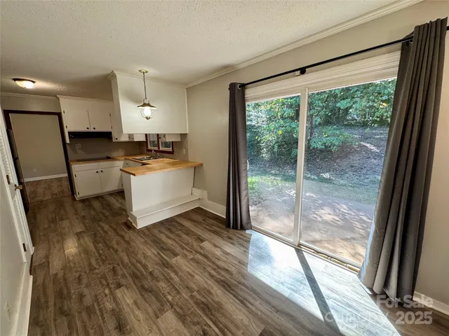 a kitchen with a sink and wooden floor