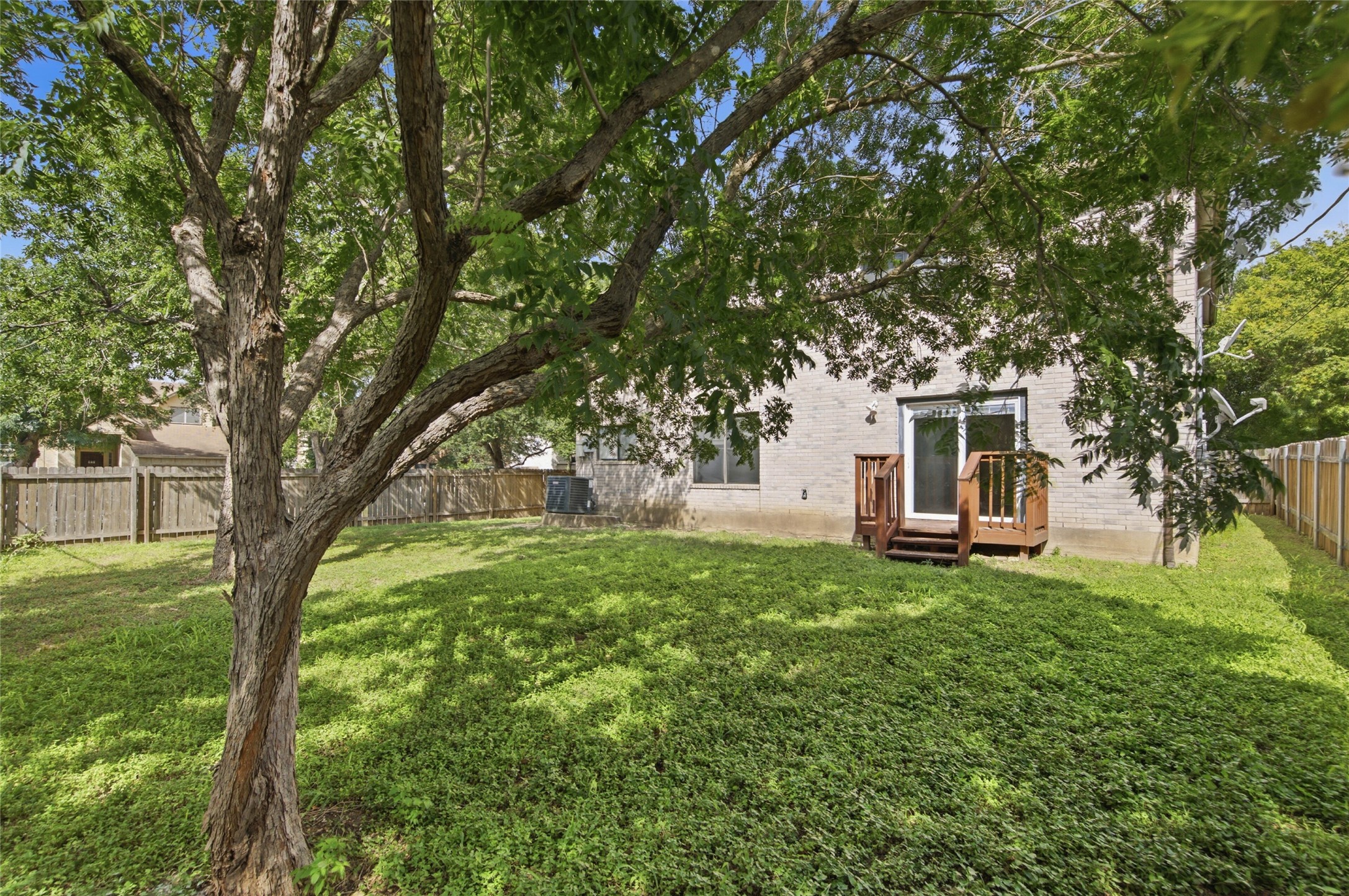 7900 Rosenberry Drive Austin, TX 78747 - Photo 22 of 27 A spacious, naturally illuminated yard offers verdant foliage and direct outdoor access.