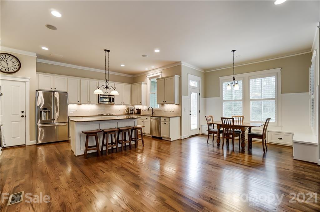 829 Elswick Court Fort Mill, SC 29708 - Photo 15 of 48 a open kitchen with stainless steel appliances dining table chairs and wooden floor