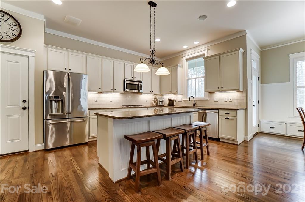 829 Elswick Court Fort Mill, SC 29708 - Photo 20 of 48 a kitchen with kitchen island granite countertop a sink a counter space stainless steel appliances and cabinets