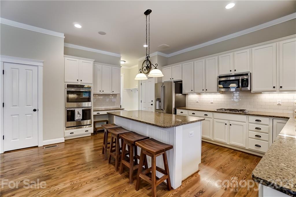 829 Elswick Court Fort Mill, SC 29708 - Photo 21 of 48 a kitchen with stainless steel appliances granite countertop a sink refrigerator and cabinets