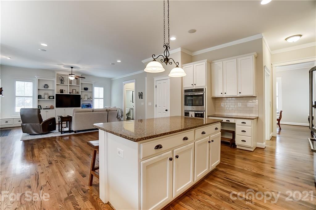 829 Elswick Court Fort Mill, SC 29708 - Photo 22 of 48 a large kitchen with stainless steel appliances granite countertop a lot of counter space and wooden floor
