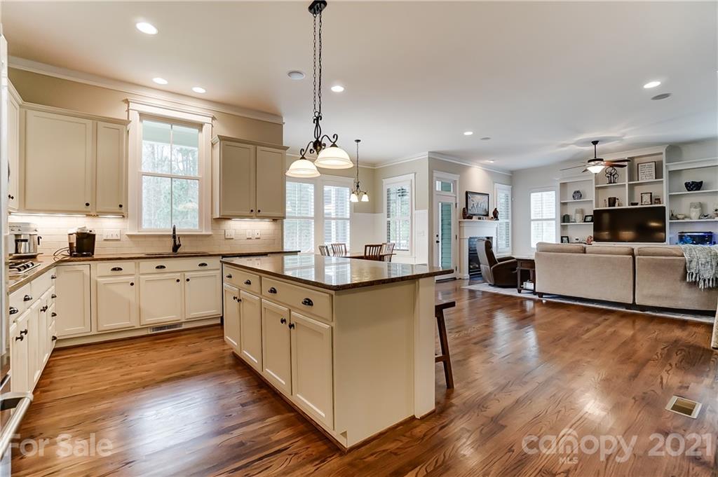 829 Elswick Court Fort Mill, SC 29708 - Photo 23 of 48 a kitchen with stainless steel appliances granite countertop wooden floors and white cabinets