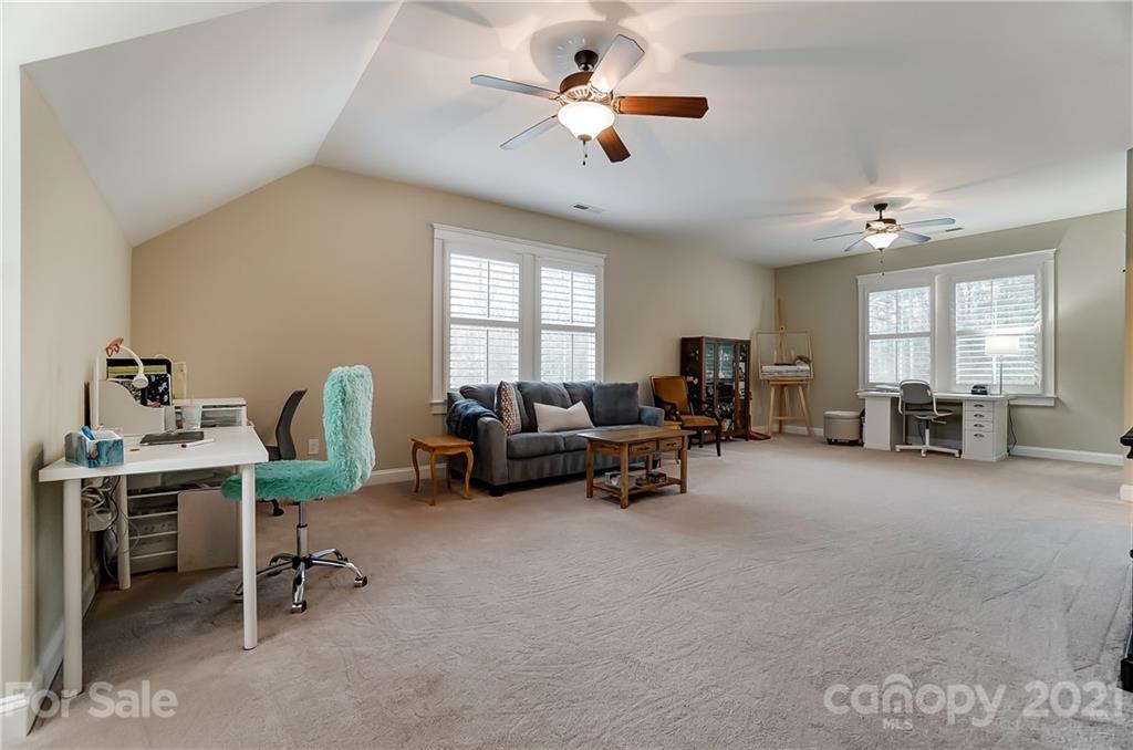 829 Elswick Court Fort Mill, SC 29708 - Photo 31 of 48 a living room with furniture and a chandelier