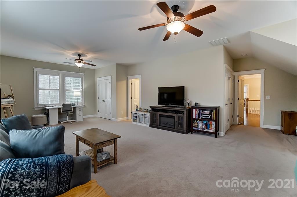 829 Elswick Court Fort Mill, SC 29708 - Photo 32 of 48 a living room with furniture and a flat screen tv
