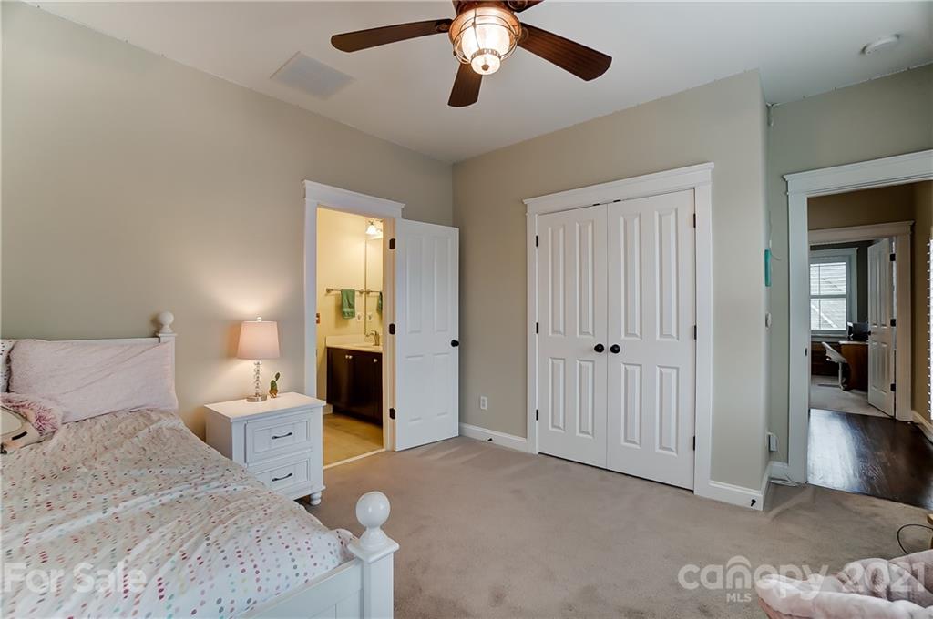 829 Elswick Court Fort Mill, SC 29708 - Photo 35 of 48 a bedroom with a bed and a chandelier