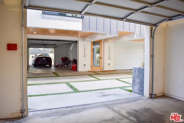 a view of a room that has a bed and a large mirror