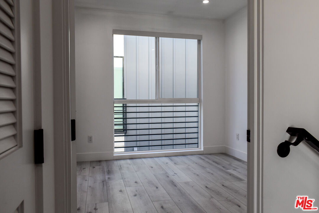 15328 Weddington Street, Unit 1 Sherman Oaks, CA 91411 - Photo 13 of 13 a view of a hallway with wooden floor and closet