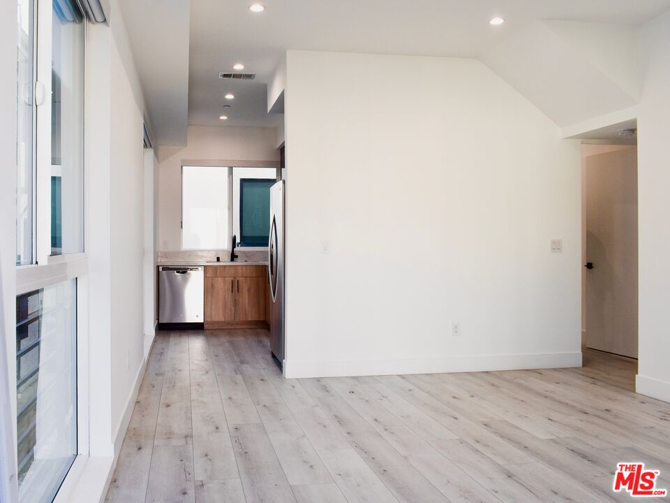 15328 Weddington Street, Unit 1 Sherman Oaks, CA 91411 - Photo 4 of 13 a view of a kitchen with a sink and wooden floor