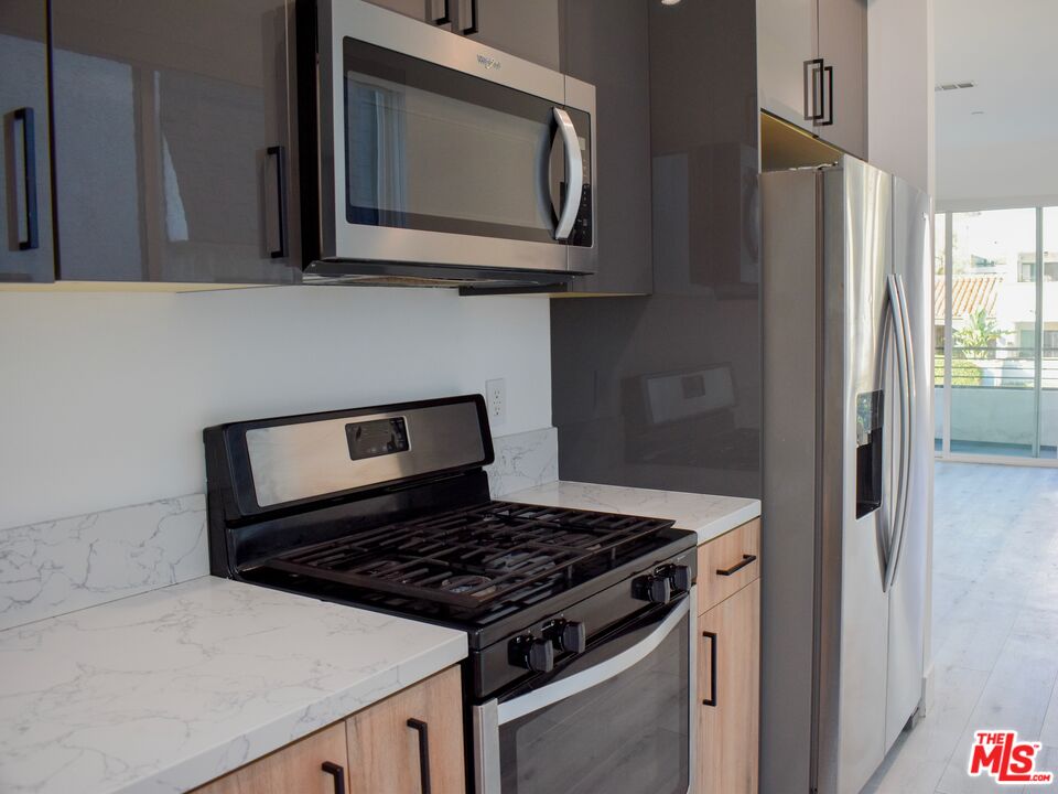15328 Weddington Street, Unit 1 Sherman Oaks, CA 91411 - Photo 9 of 13 a stove top oven sitting inside of a kitchen