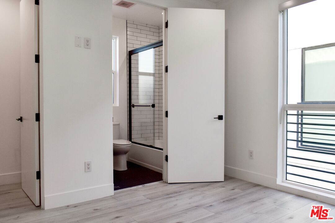 15328 Weddington Street, Unit 1 Sherman Oaks, CA 91411 - Photo 10 of 13 a view of a hallway with wooden floor and closet