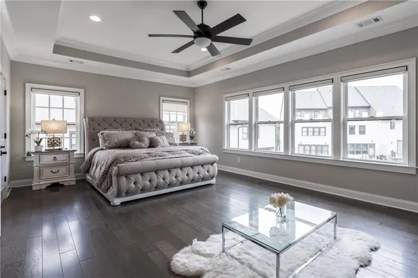 a bedroom with a bed and a large window