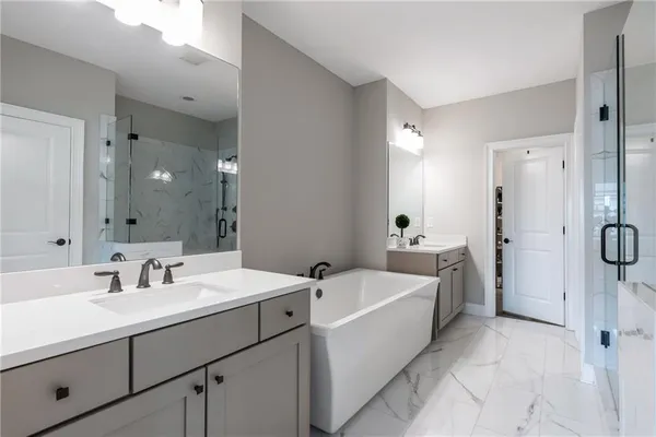 a bathroom with a sink a tub and mirror