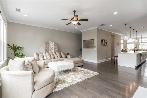 a living room with furniture and a wooden floor