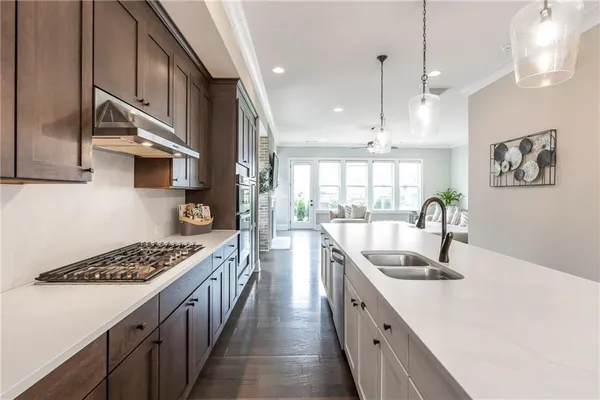a kitchen with stainless steel appliances granite countertop a sink stove and cabinets