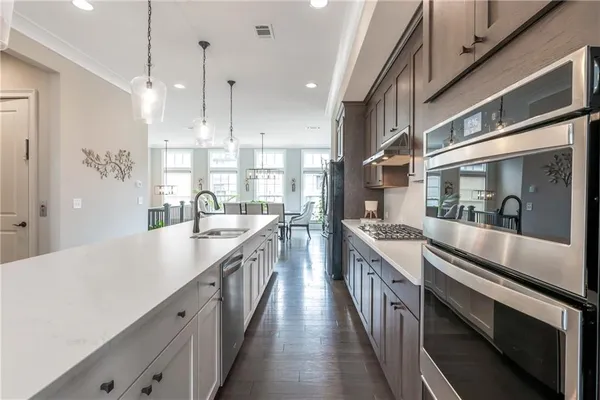 a kitchen with stainless steel appliances sink stove and cabinets