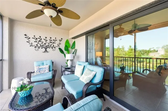 a living room with furniture and a floor to ceiling window
