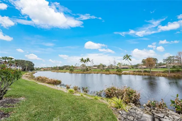 a view of a lake with houses in the back