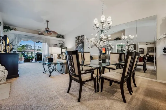 a view of a dining room with furniture and chandelier
