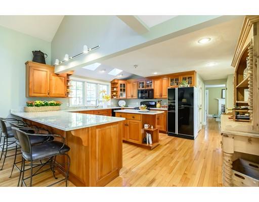25 Maple Avenue Boxford, MA 01921 - Photo 6 of 36 a open kitchen with stainless steel appliances kitchen island granite countertop a table chairs and a refrigerator