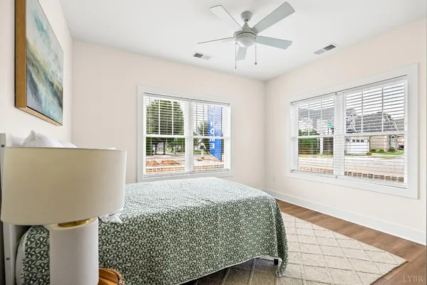 a bedroom with a bed and a large window