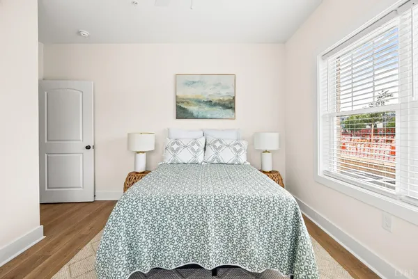 a bedroom with a bed and wooden floor