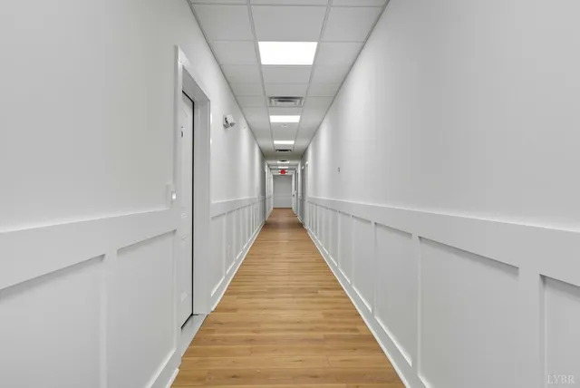 a view of a hallway with stairs and a couch