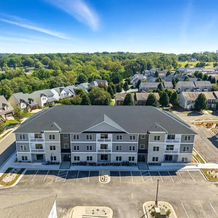 an aerial view of residential houses with cars