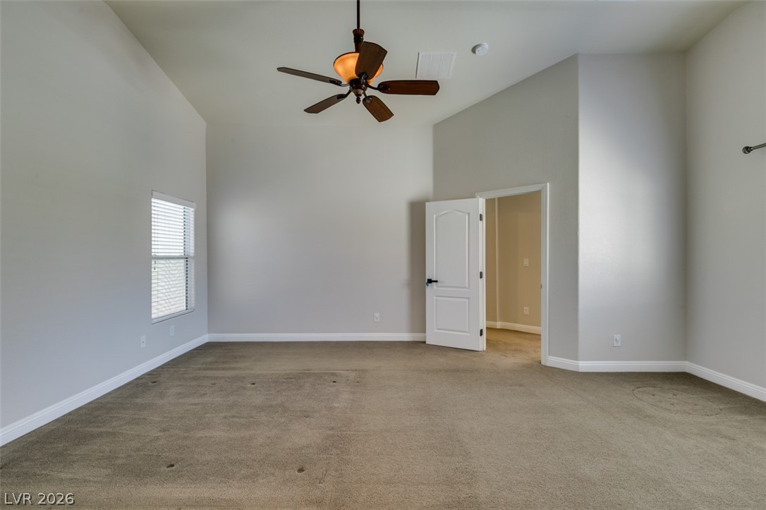 8909 Houston Ridge Avenue Las Vegas, NV 89178 - Photo 35 of 45 A well-proportioned bedroom with a functional ceiling fan and practical carpeting awaits your personal touch.