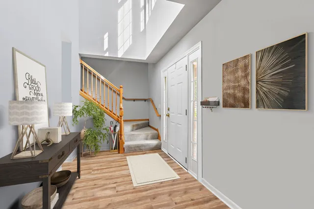 a view of a hallway with wooden floor and staircase