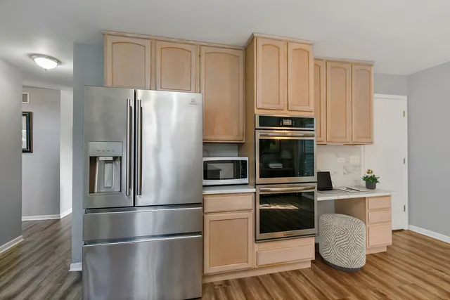 a kitchen with granite countertop stainless steel appliances and wooden cabinets