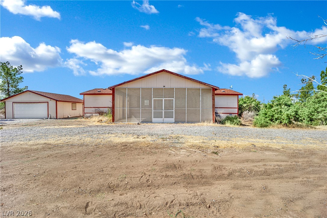 4361 Maple Road Pahrump, NV 89048 - Photo 35 of 46 A robust metal roof crowns this rural home, offering shelter and durability in a natural setting.