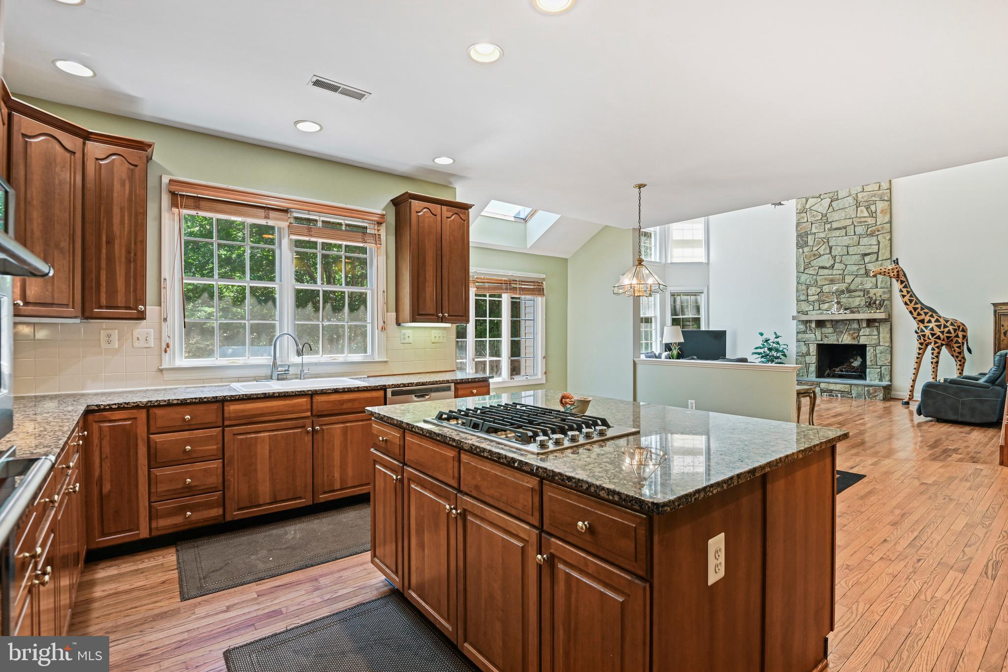 10509 Dunn Meadow Road Vienna, VA 22182 - Photo 15 of 81 a kitchen with kitchen island granite countertop a stove and a sink