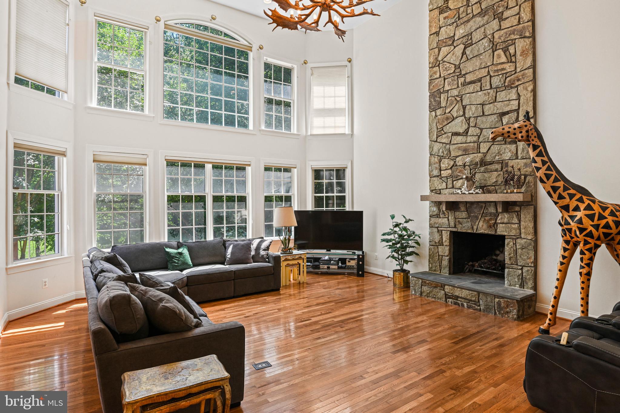 10509 Dunn Meadow Road Vienna, VA 22182 - Photo 19 of 81 a living room with furniture a fireplace and a flat screen tv