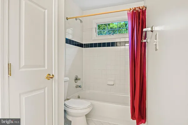 a view of an empty room and a bathroom with mirror